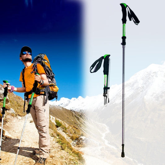 Adjustable trekking poles with green shafts and black grips, worn wrist straps