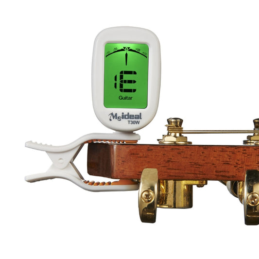 White clip-on guitar tuner attached to a guitar headstock