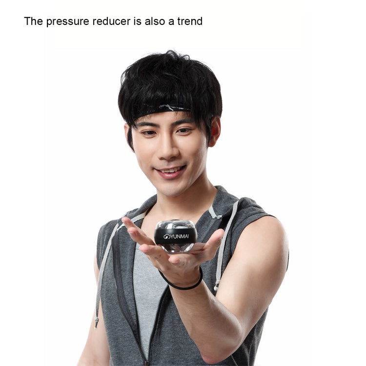 Black YUNMAI wrist gyroball spinner exerciser in hand for forearm workout