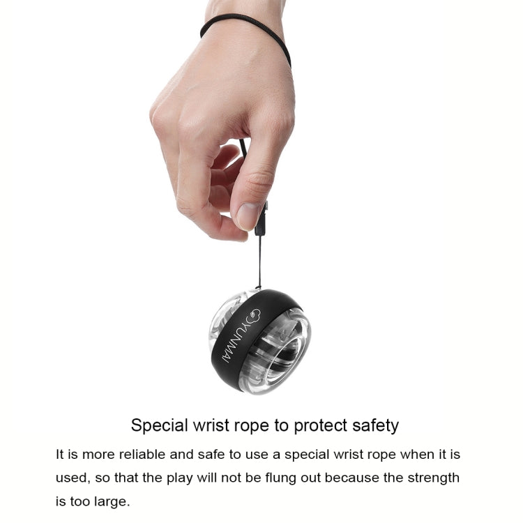 Hand holding a black YUNMAI wrist gyroball spinner connected by wrist cord