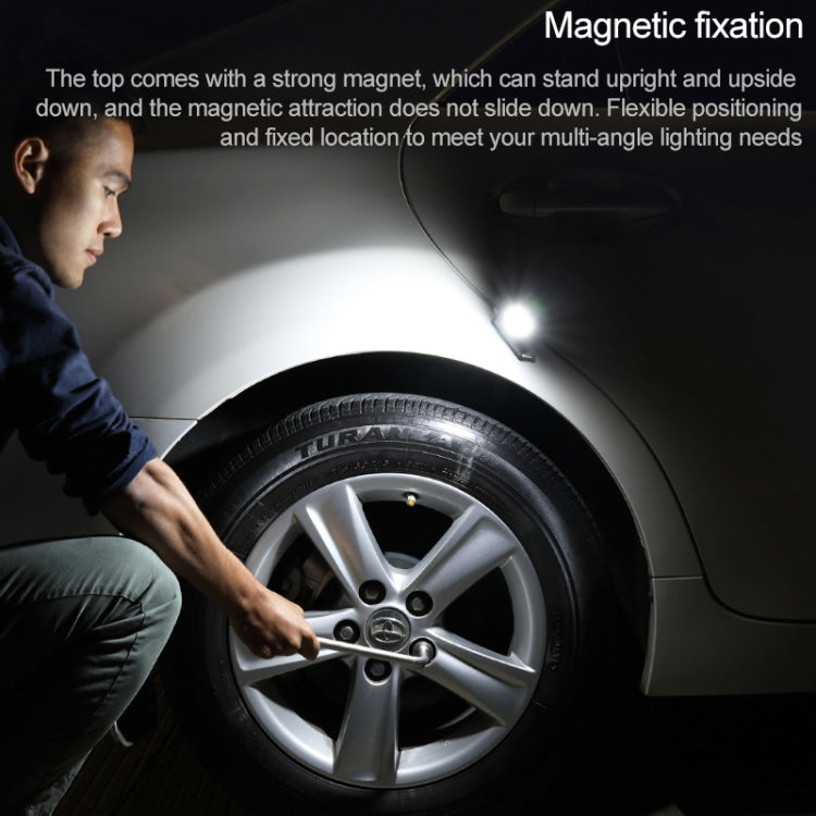 Emergency survival hammer with bright white light positioned near a vehicle wheel