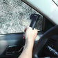 Emergency survival hammer held toward a car window, shining white light on glass