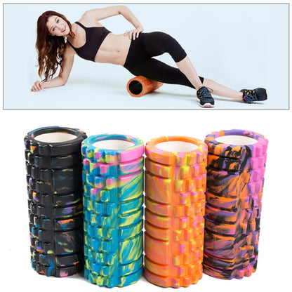 Orange high-density foam roller used for stretching on the floor
