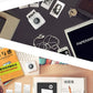 White portable thermal photo printer on a desk with photo prints