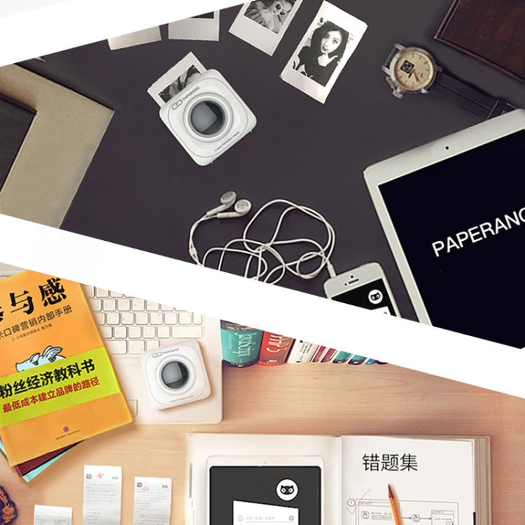White portable thermal photo printer on a desk with photo prints