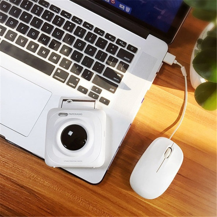 White portable thermal printer on desk connected to laptop via USB cable