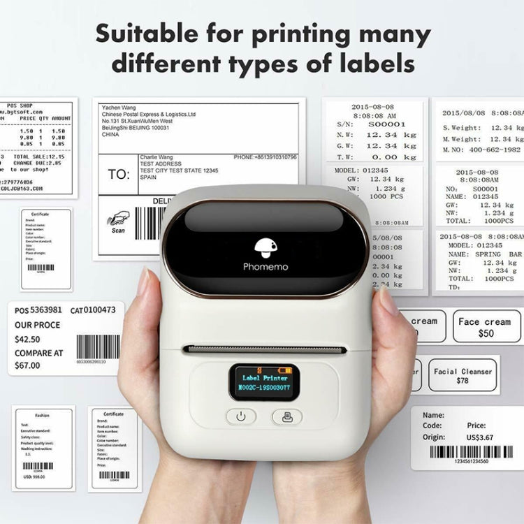 White Phomemo handheld thermal label printer held toward different label samples