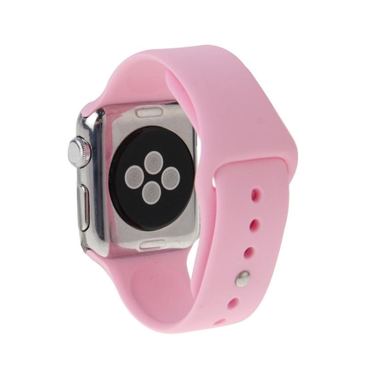 Pink rubber sport watch band with pin-and-tuck closure shown on Apple Watch