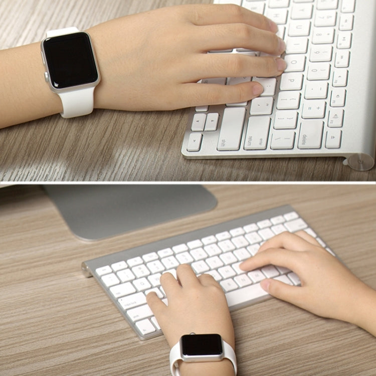 White rubber Apple Watch band with pin-and-tuck closure on wrist, 42mm smartwatch