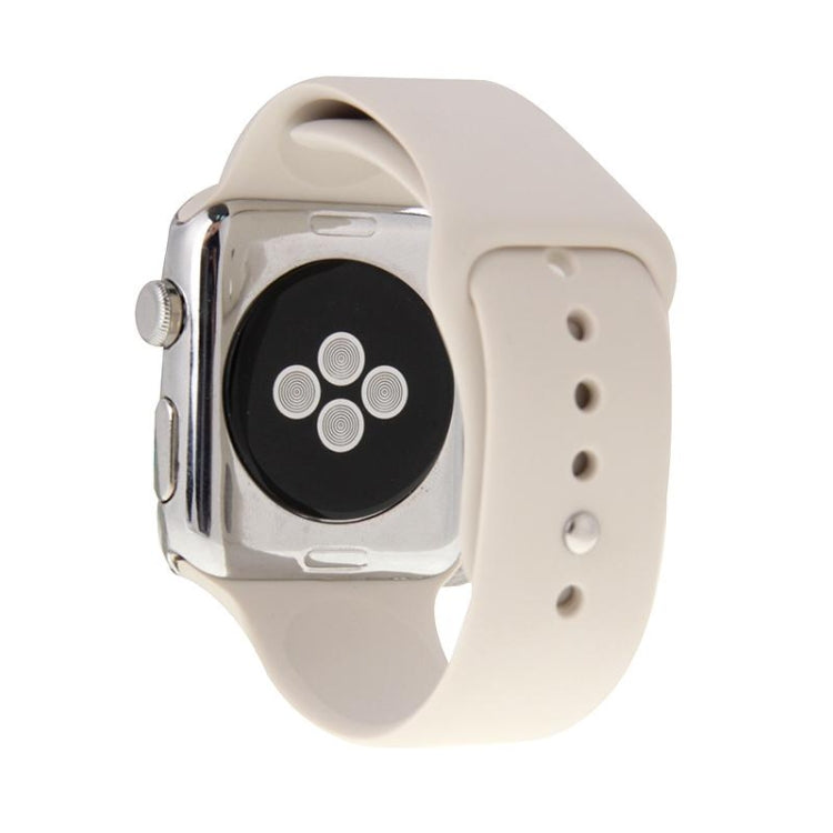 Beige rubber sport watch band with pin-and-tuck closure shown on Apple Watch