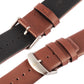 Leather watch band close-up with silver buckles on coffee brown and dark brown straps