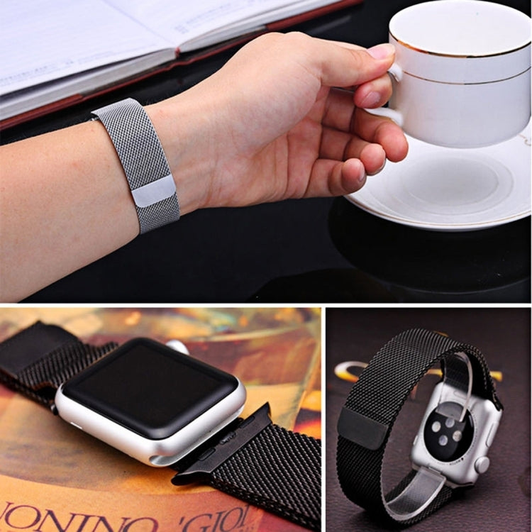 Black milanese loop watch band on wrist, magnetic clasp visible