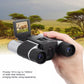 Handheld binocular digital telescope showing an image on the LCD screen