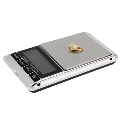 Compact digital pocket scale with dark display and silver metal body, 0.1 g resolution