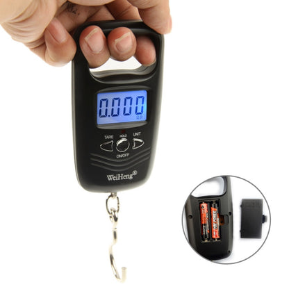 Black digital luggage hook scale with LCD screen and hanging chain, held in hand