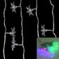 Multi-colored LED string lights, green and purple glowing star bulbs on a cable