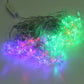 Multi-colored LED string lights with star bulbs glowing green and blue-purple