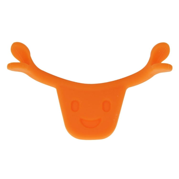 Orange smile maker tool, U-shape with two rounded handles and a small smile face