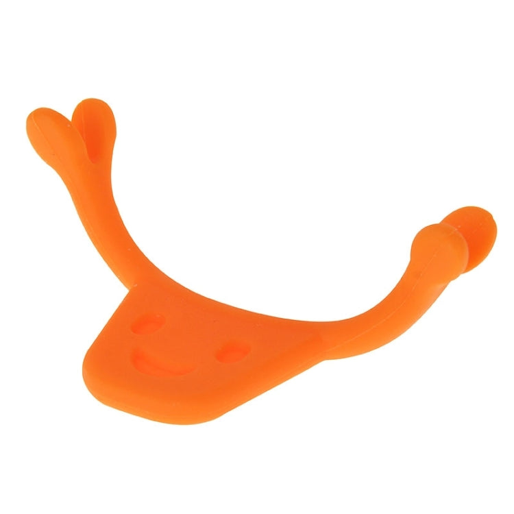 Orange smile maker tool in U-shape with rounded handles and smile face design