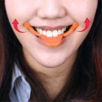 Person wearing an orange smile maker tool around the mouth for a wider smile