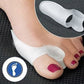 Pair of white silicone toe separator braces on toes, open toe pad