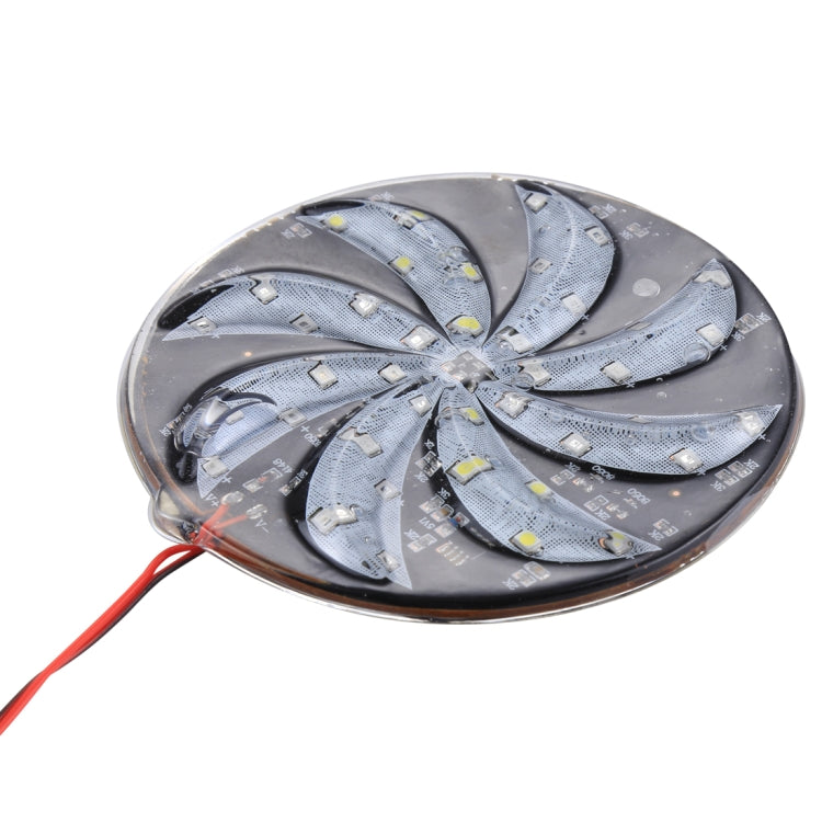 Close-up of round LED windmill light with silver LED blades and red leads