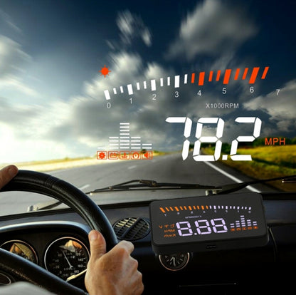 Car HUD head-up display projecting speed and gauges over dashboard; black unit with screen.