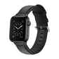 Black leather watch strap with round buckle and perforated holes, paired with smartwatch