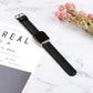 Black leather smartwatch strap with metal buckle and perforated sizing holes