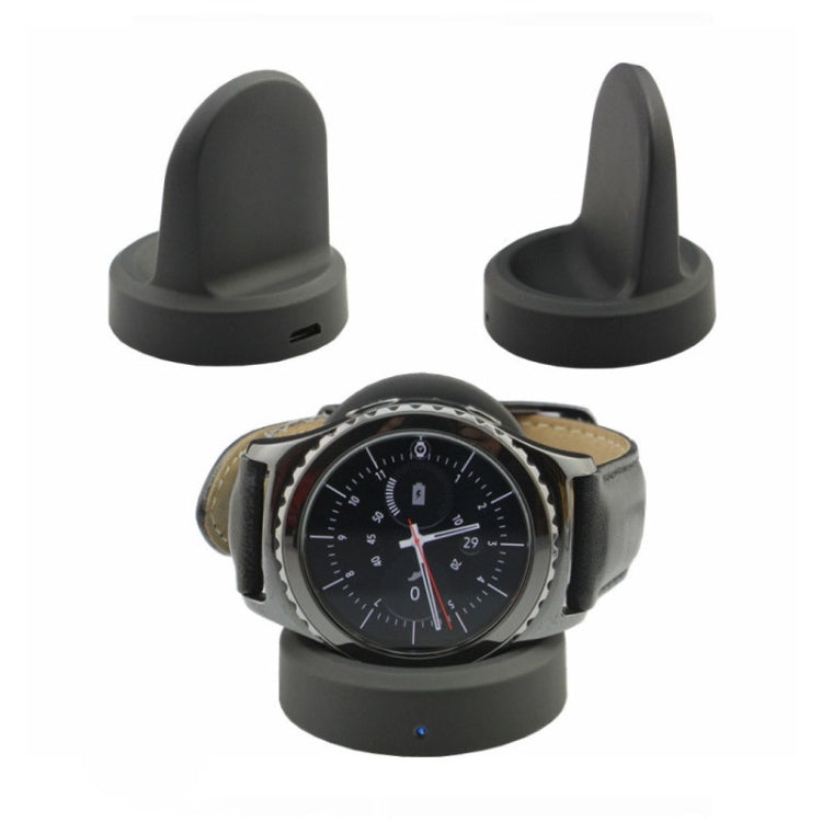 Black charging dock holding a smartwatch in the cradle charging position
