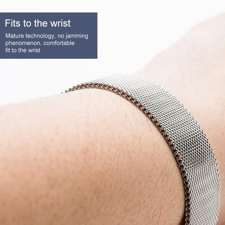 Silver Milanese mesh watch band with metal clasp on wrist