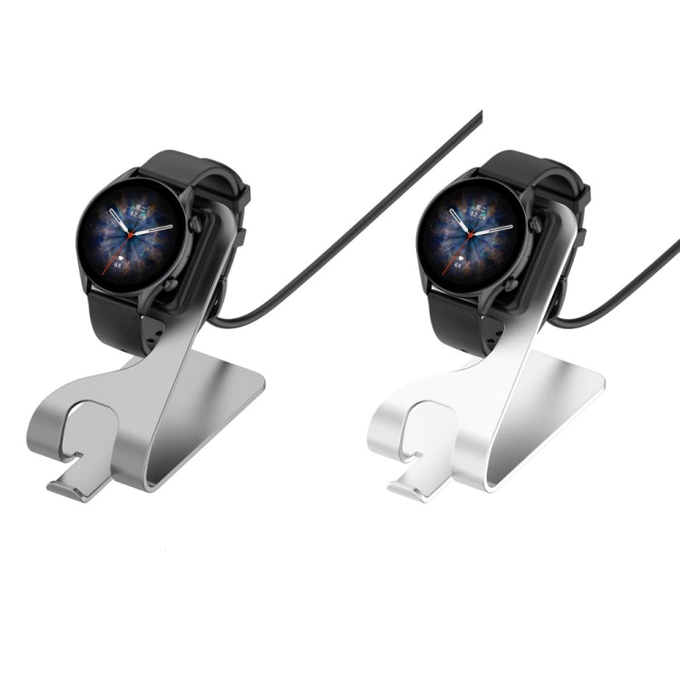 Silver and black magnetic charging stand with dual watch cradles, angled view.