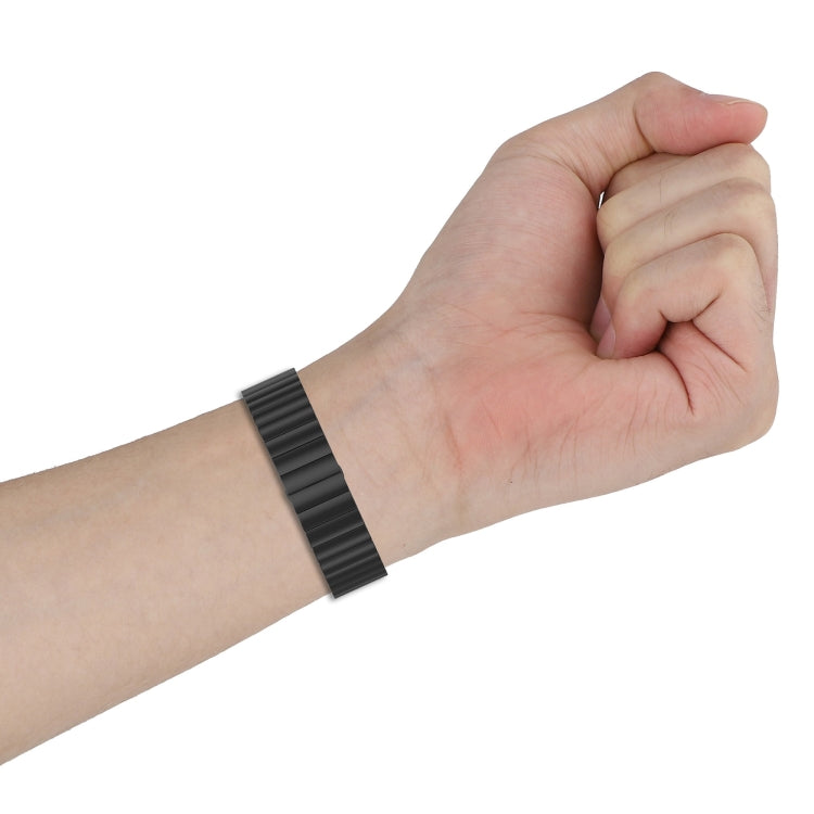 Black metal bead watch strap worn on wrist with no watch face