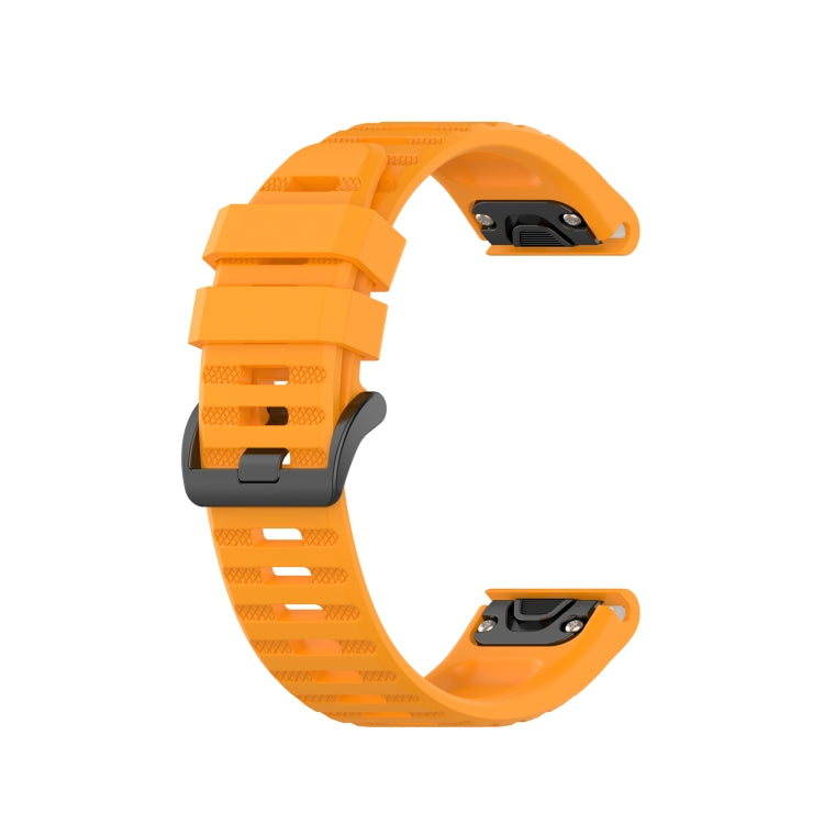 Orange silicone sports watch strap with perforated holes and buckle, side view