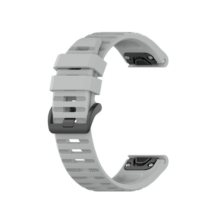 Light gray silicone sports watch strap with perforated band and adjustable buckle.