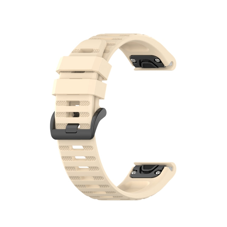 Beige silicone sports watch strap with perforated band and adjustable buckle.