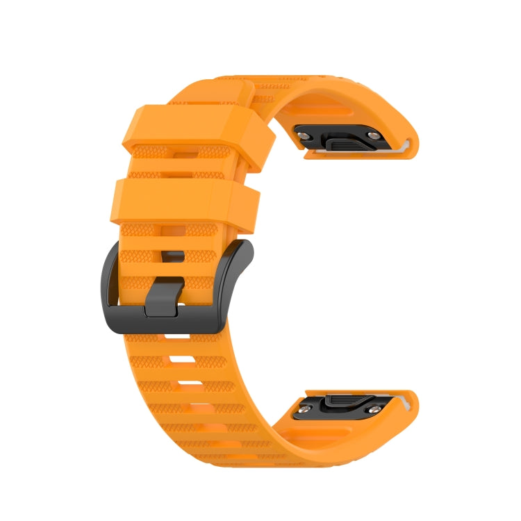 Silicone sports watch strap, orange, with adjustable holes and snap buckle.