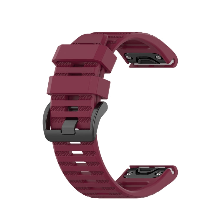 Silicone sports watch strap, burgundy red, with adjustable holes and buckle.