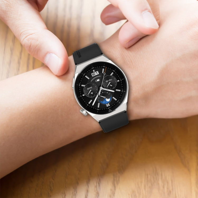 Black silicone watch strap with silver buckle on wrist