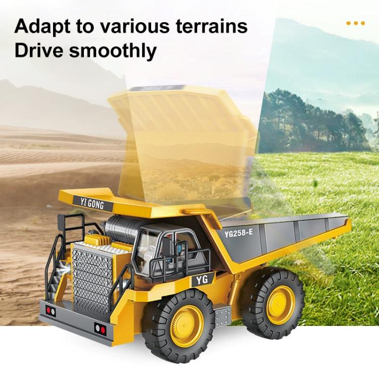 Yellow and gray RC dump truck with raised cargo bed and four big traction tires