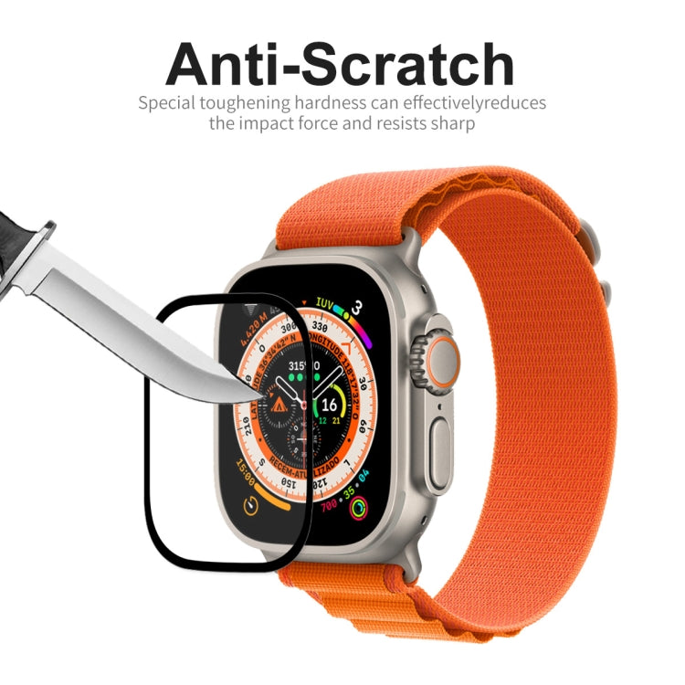 Tempered glass watch screen protector on display with metal tool near the surface