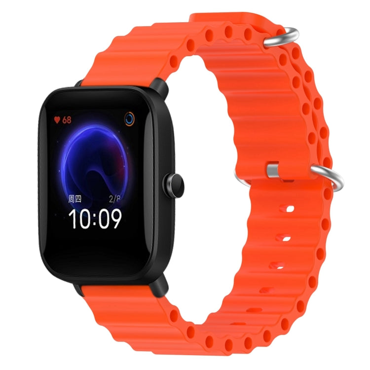 Orange silicone watch band with perforated links and metal pin clasp