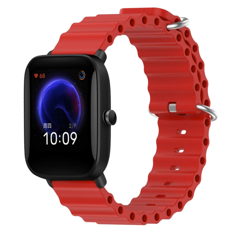 Red silicone watch band with perforated links and metal pin clasp