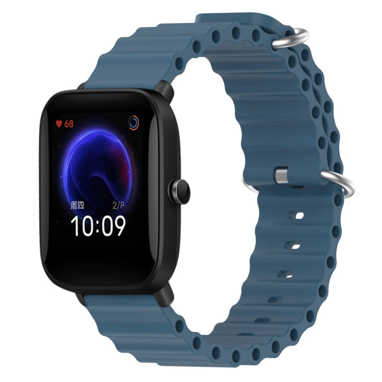 Blue silicone watch band with perforated holes and metal pin clasp