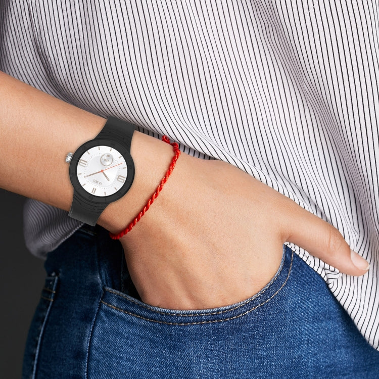 Silicone watch band on wrist with red strap and perforated links