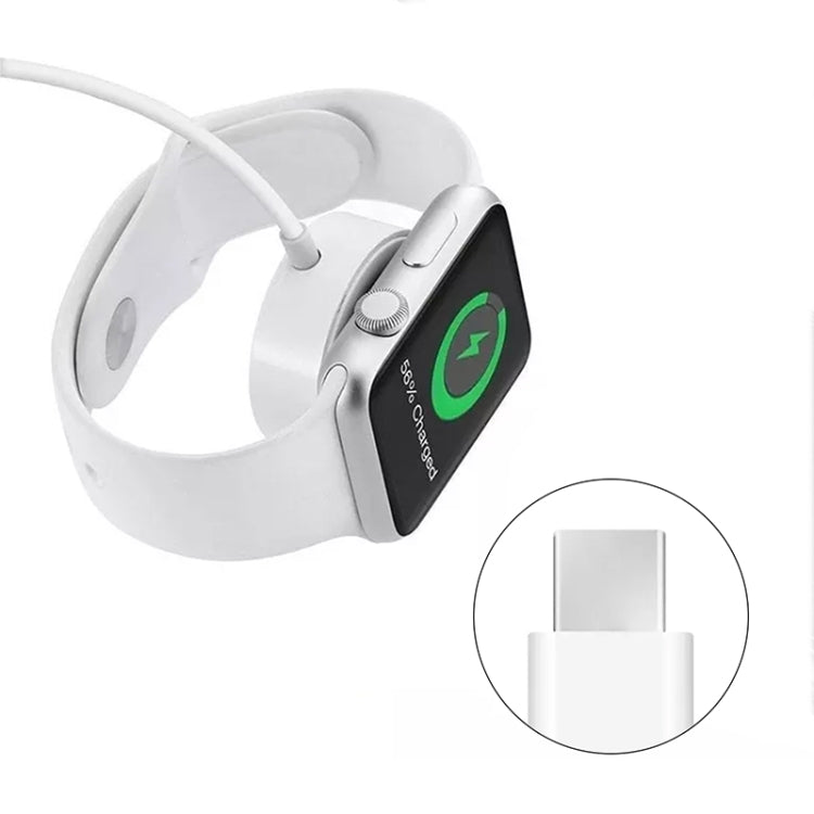 Magnetic charger puck attached to a white smartwatch with charging cable