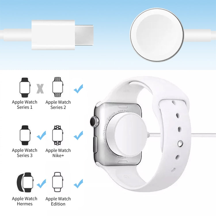 Magnetic charging cable with round puck and white smartwatch on wristband