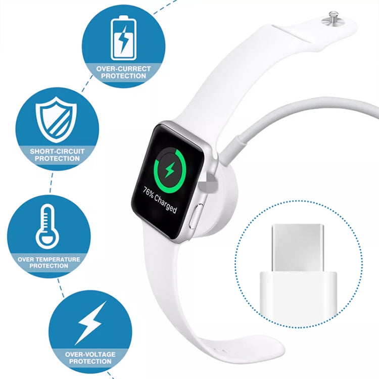 White smartwatch charging with magnetic puck and USB-C charging cable