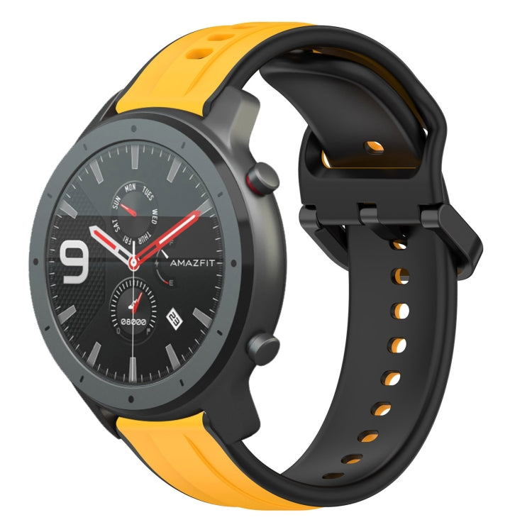 Two-color silicone watch band with orange outer loops and black perforated strap.