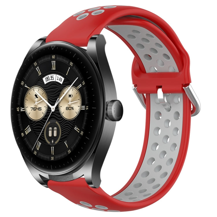 Black and red perforated silicone sports watch band with vent holes and buckle tabs